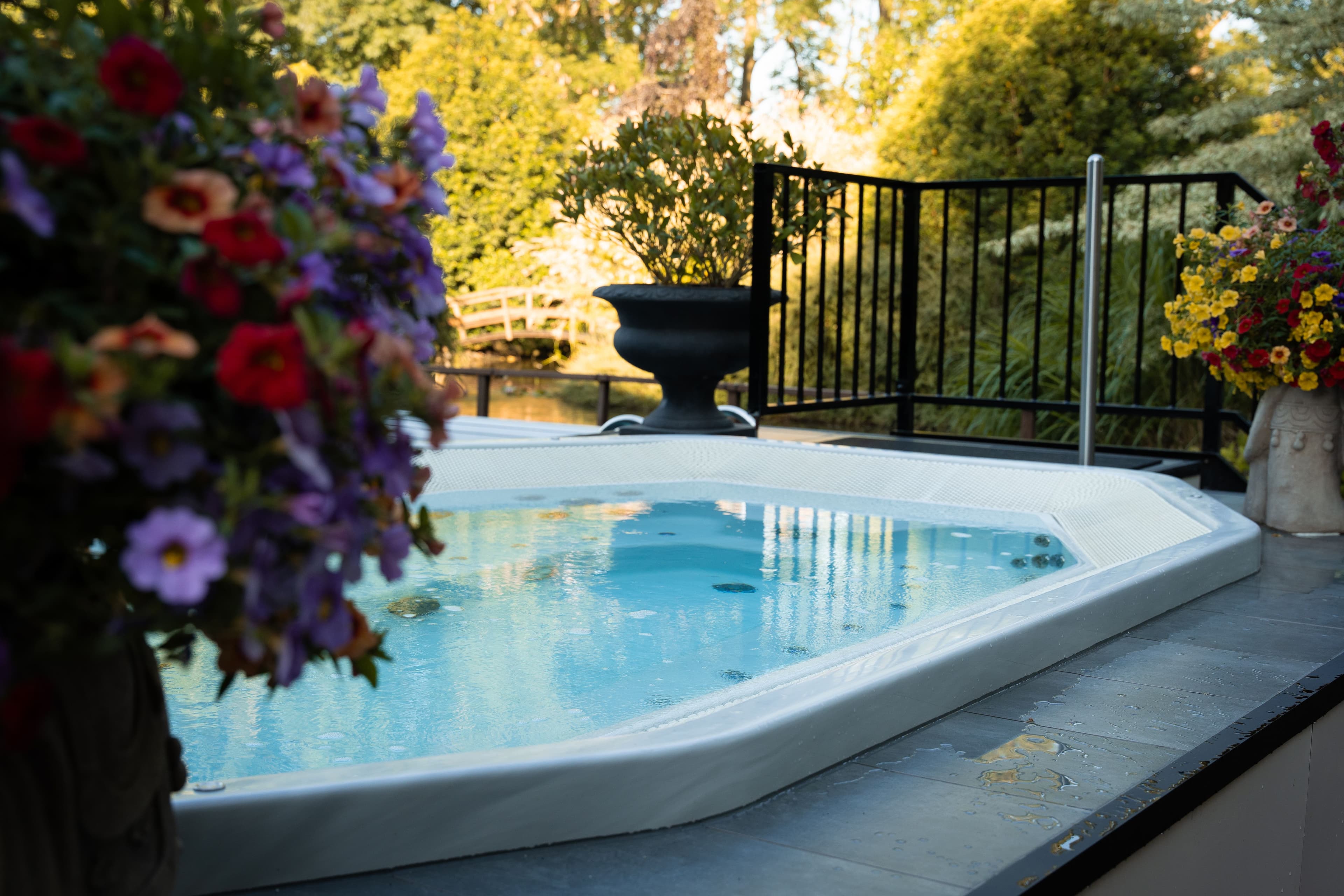 Bubbelbad omgeven door bloemen en natuur in de buitenruimte van Thermen Binnenmaas
