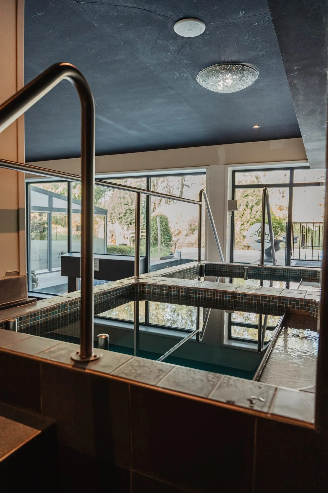 Heated indoor pool with large windows onto the garden